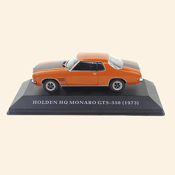 a model of an orange car on a black base